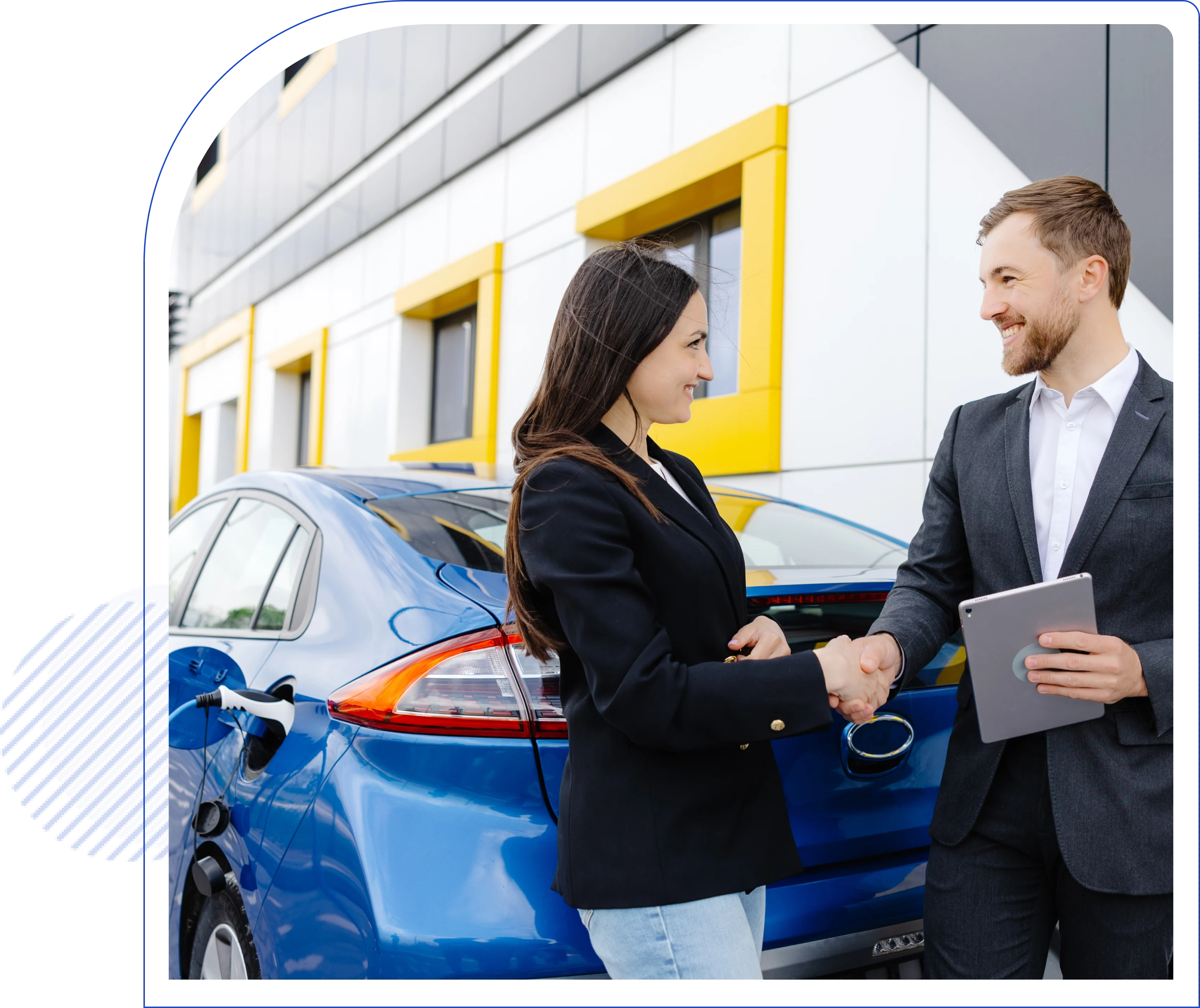 Man and woman shaking hands in front of a blue electric car, parked near a modern building. Woman holds car keys; man holds a tablet. Both are smiling.